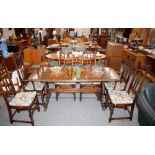 A dark Ercol refectory type dining table raised on