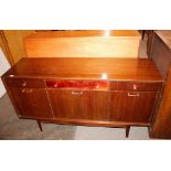 A dark teak sideboard, fitted three drawers above