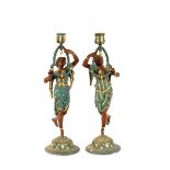 A pair of painted Spelter candlesticks in the form
