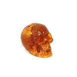An amber coloured skull ornament