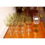 A set of eleven green tinted long stem wine glasse