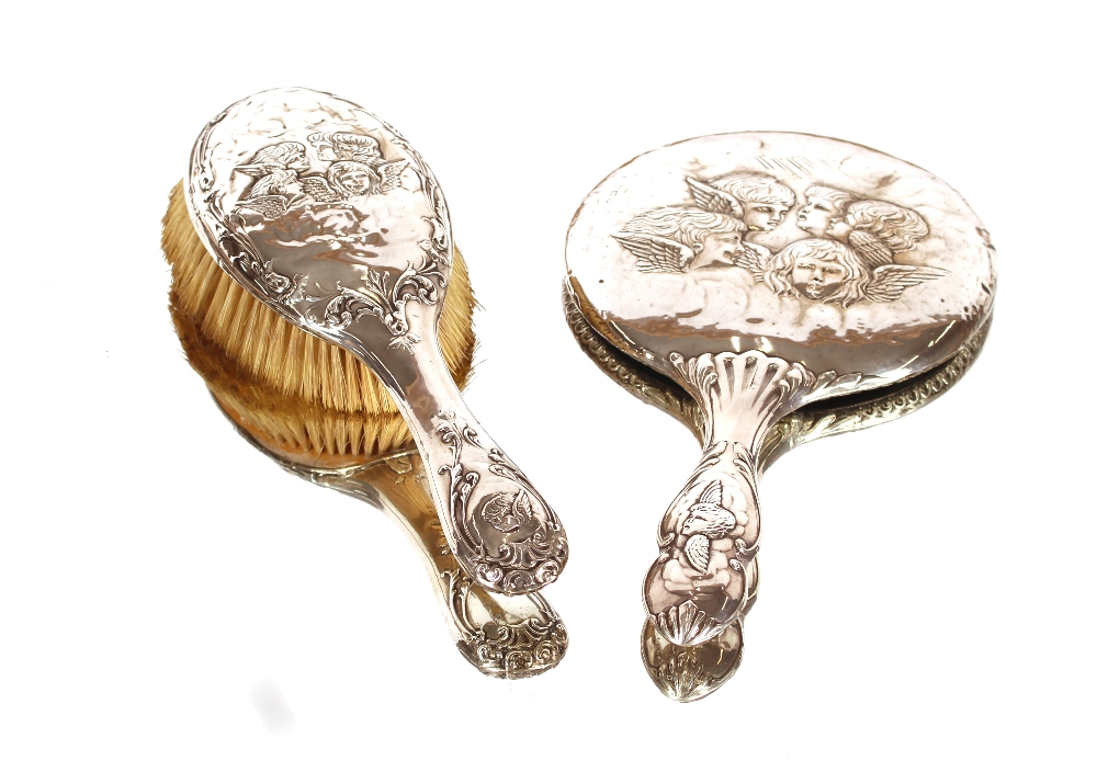 An Edwardian silver backed dressing table hand mir