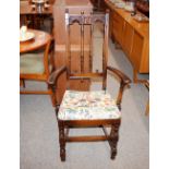 A set of six dark Ercol carved dining chairs, with
