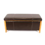 A leather upholstered ottoman