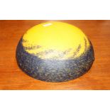 A yellow and black mottled glass lampshade, in the