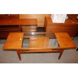 A teak G-plan two tier coffee table with glass ins