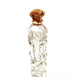 A cut glass scent bottle with yellow metal hinged