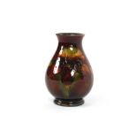 A small Moorcroft pottery baluster vase having lea