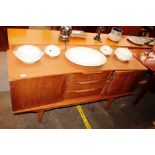 A teak G-plan style sideboard of concave shape, fi