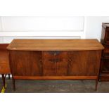 A teak sideboard fitted three central drawers, fla