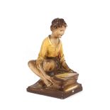 After S Jones, glazed pottery figure of a seated b