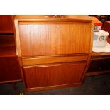 A Remploy teak bureau the fall opening to reveal a