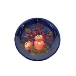 A Moorcroft "Finch and Fruit" patterned plate, 26c