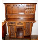 An Arts & Crafts design carved oak dresser, the ra