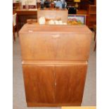 A teak drinks cabinet, with drop down compartment,