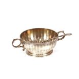 A silver two handled bowl of fluted design, retail