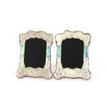 A pair of silver and enamel decorated photograph f