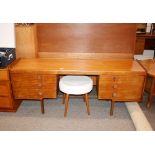 A teak kneehole dressing table, fitted six drawers