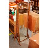A 1930's oak cheval mirror with bevelled plate
