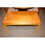 A teak and tubular metal framed oblong coffee tabl