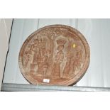 A large African carved wooden plaque depicting fig