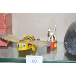 A wind-up toy bee; and one other small toy