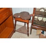 An oak shaped top two tier table with carved decor