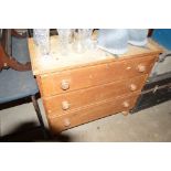 A Victorian stripped pine three drawer chest