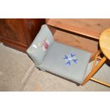 A needlework upholstered adjustable stool