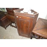 A Georgian oak hanging corner cupboard