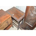 A nest of four carved oak occasional tables