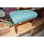 A mahogany and green upholstered stool