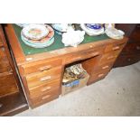 A golden oak writing desk with green leather inset