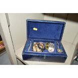 A blue leather jewellery box containing various co