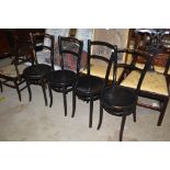 A set of four black painted bentwood chairs