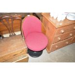 A retro style plywood and upholstered swivel chair