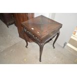 An Edwardian mahogany envelope card table, fitted