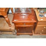 A hardwood bedside cupboard fitted single drawer