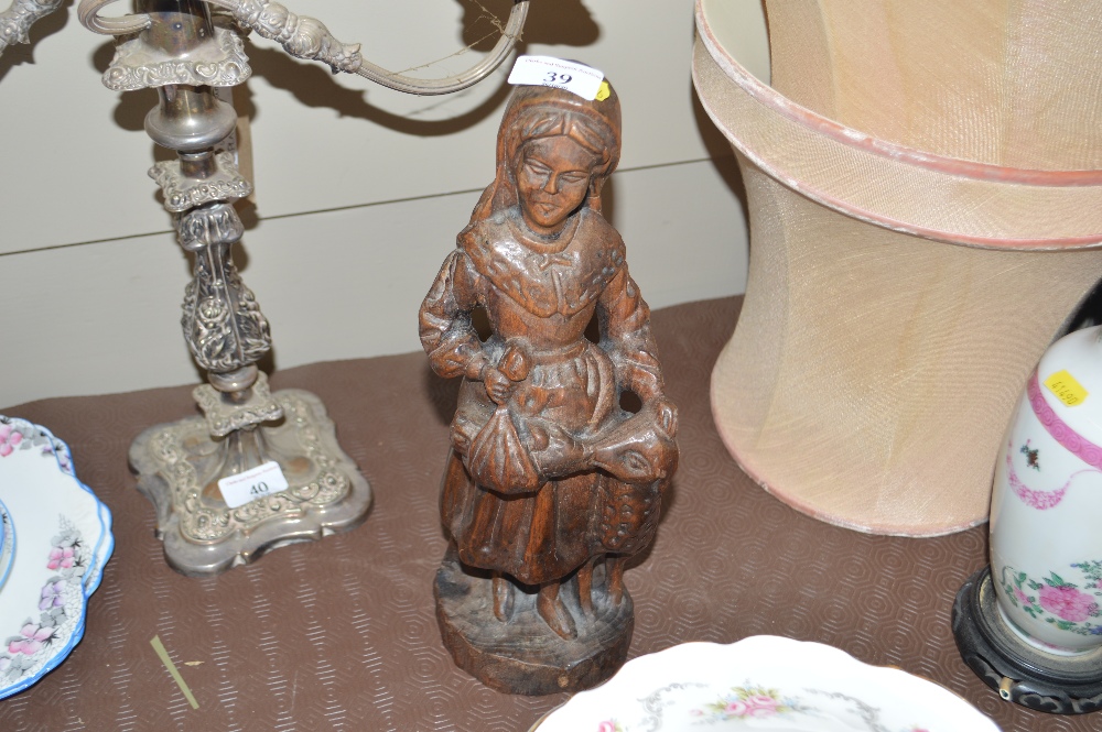 A carved wooden figure group on the form of a maid