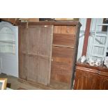 A Victorian pine cupboard with sliding doors for r