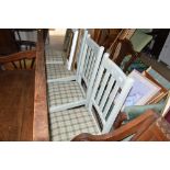 A set of four painted slat back dining chairs