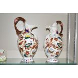 A pair of Victorian china jugs with floral decorat