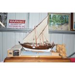 A wooden model boat on stand; together with a mode
