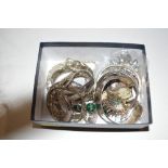 A box of silver and white metal bangles and jewell