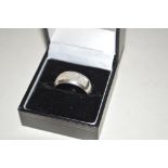 A silver and mother of pearl ring