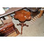 A reproduction mahogany shaped top occasional tabl