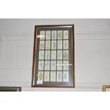 A framed set of Players cigarette cards depicting