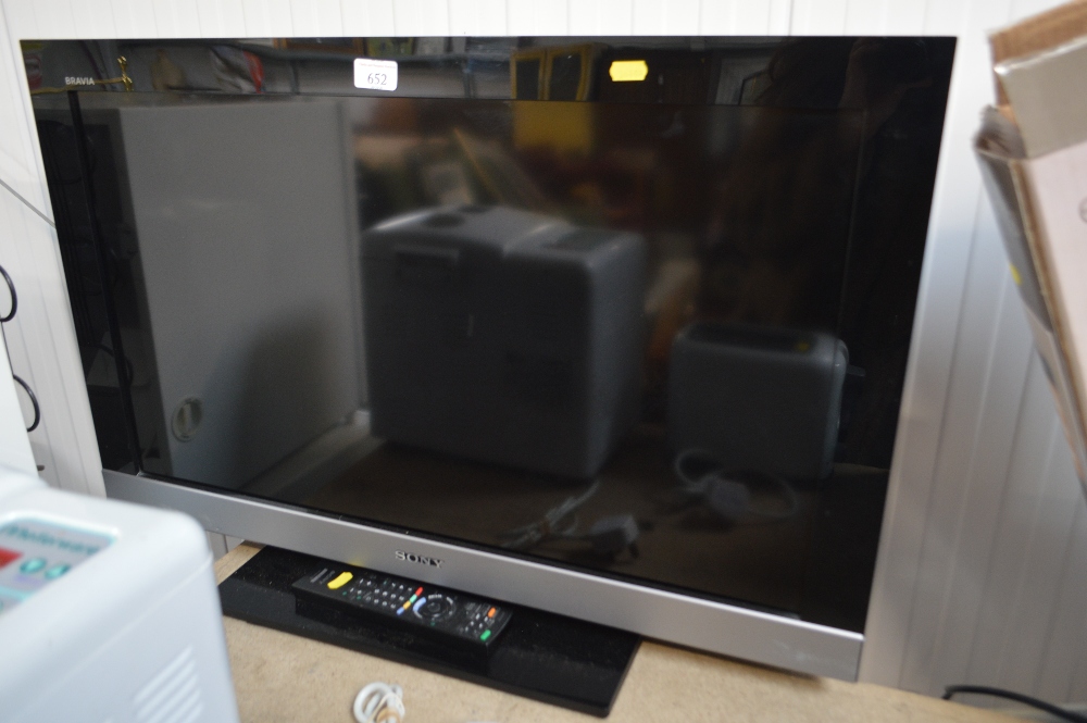 A Sony Bravia flat screen television with remote c