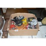 A box containing various fishing reels to include