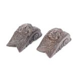 A pair of antique carved oak appliqué, in the form of angel masks possibly from a church pew, 16cm